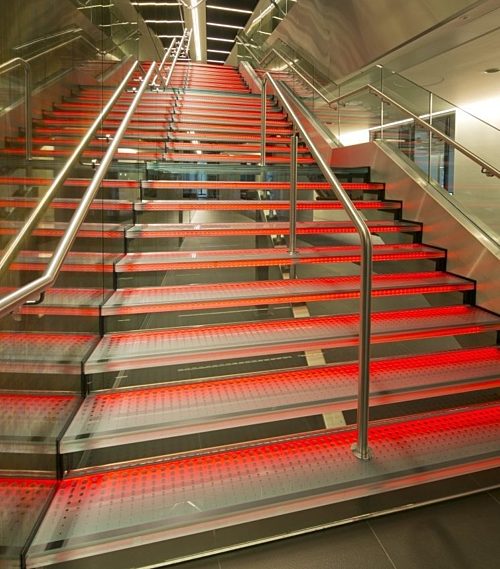 Aon staircase lit in red